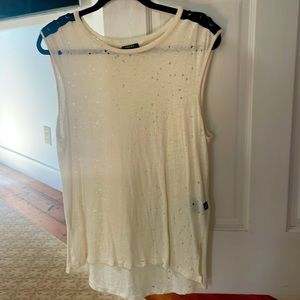 Cream colored muscle tank. Detailing at shoulder. Distressed. Size S